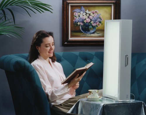 [Picture of woman reading book with Bio-Light bright light therapy system for seasonal affective disorder]